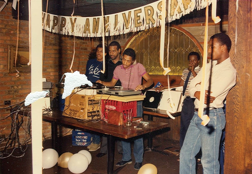 Delano Smith DJing while Ken Collier and crew look on. Photo courtesy of Dan Bean.